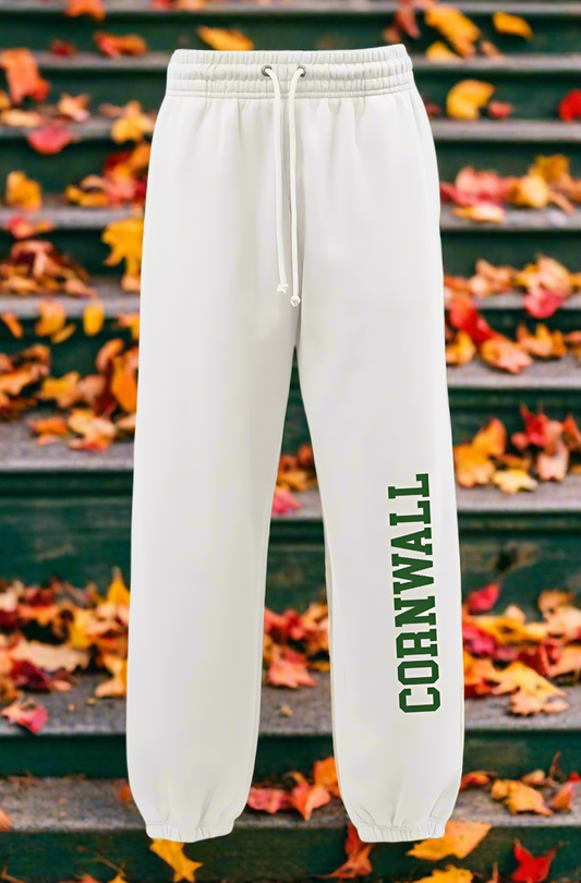 White sweatpants with 'Cornwall' printed in green on a white background